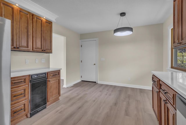9315 Kingsley Dr, Onsted, MI 49265 - kitchen featuring freestanding refrigerator, light countertops, brown cabinets, light wood finished floors, and baseboards
