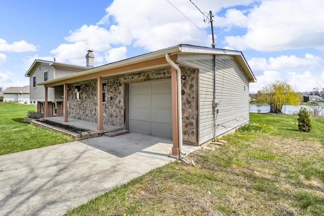 9315 Kingsley Dr, Onsted, MI 49265 - exterior space with a porch, a front lawn, a garage, driveway, and a chimney