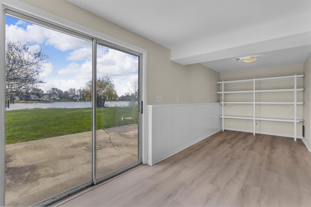 9315 Kingsley Dr, Onsted, MI 49265 - interior space with a water view, wainscoting, and wood finished floors