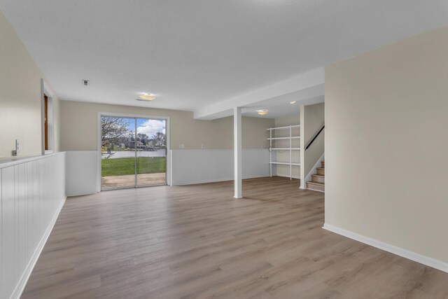 9315 Kingsley Dr, Onsted, MI 49265 - basement with stairway, light wood-type flooring, and baseboards