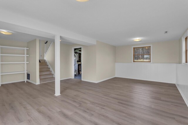 9315 Kingsley Dr, Onsted, MI 49265 - below grade area featuring baseboards, visible vents, wood finished floors, and stairs