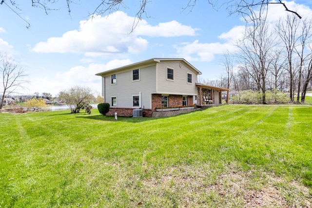 9315 Kingsley Dr, Onsted, MI 49265 - back of house featuring brick siding, central AC, and a yard