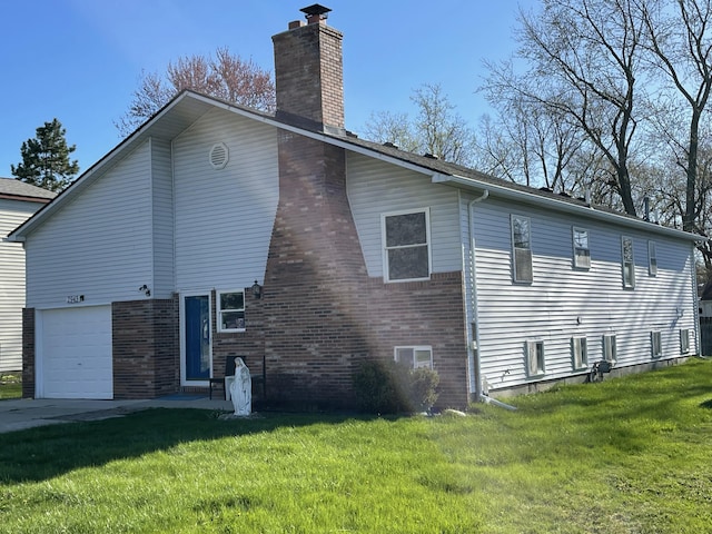 view of side of home featuring a chimney, brick siding, a yard, and an attached garage