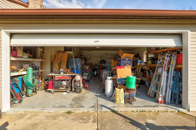 garage featuring concrete driveway