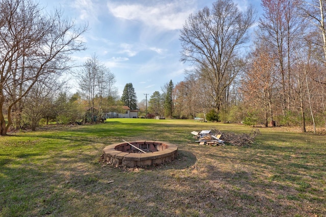 view of yard with an outdoor fire pit