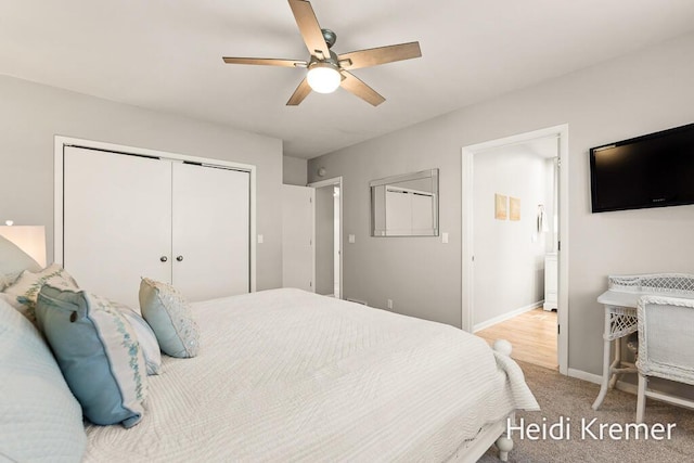 carpeted bedroom with ceiling fan, connected bathroom, a closet, and baseboards
