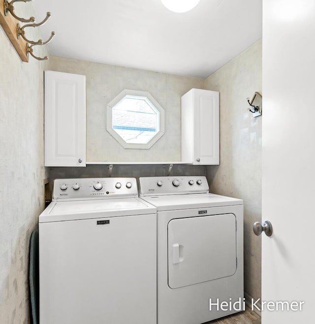 laundry room with cabinet space and washing machine and clothes dryer