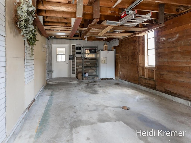 garage with white refrigerator with ice dispenser