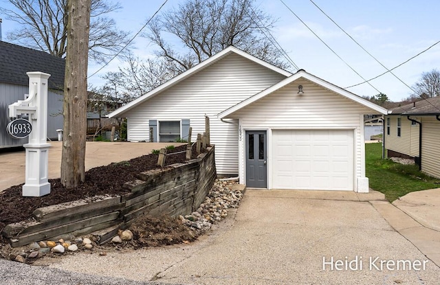 single story home featuring concrete driveway