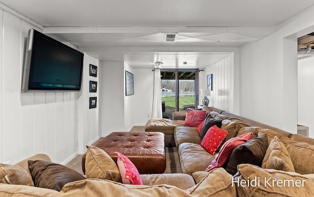 living room with baseboards and visible vents