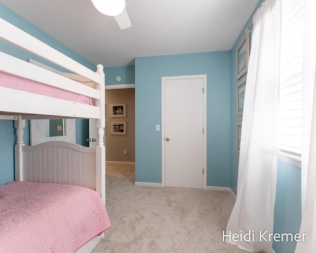 bedroom featuring baseboards, ceiling fan, and carpet floors
