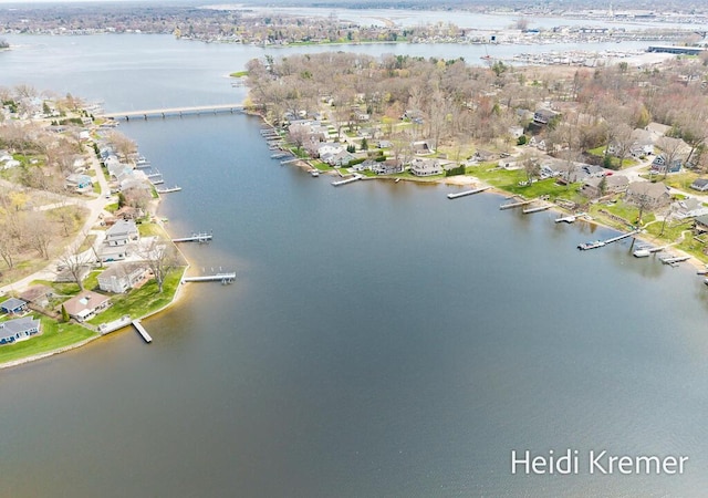 birds eye view of property with a water view and a residential view