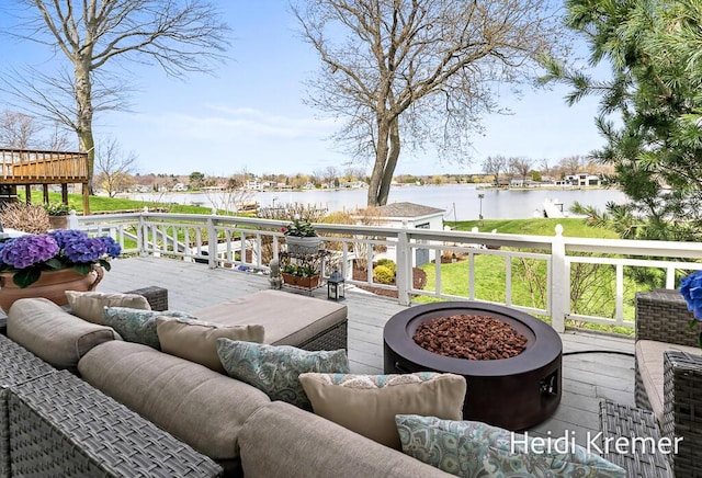wooden terrace with outdoor lounge area and a water view