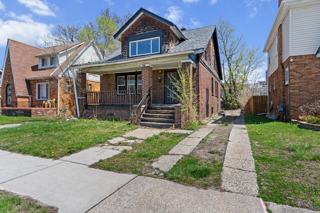 15374 Birwood St, Detroit, MI 48238 - bungalow-style home featuring covered porch, brick siding, and a front lawn