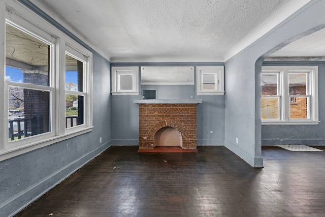 15374 Birwood St, Detroit, MI 48238 - unfurnished living room with wood-type flooring, a textured ceiling, and a healthy amount of sunlight