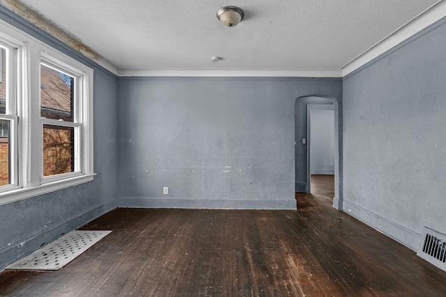 15374 Birwood St, Detroit, MI 48238 - empty room featuring wood-type flooring, arched walkways, visible vents, and a textured ceiling