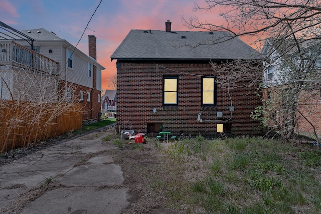 15374 Birwood St, Detroit, MI 48238 - back of property with a chimney, brick siding, and a shingled roof