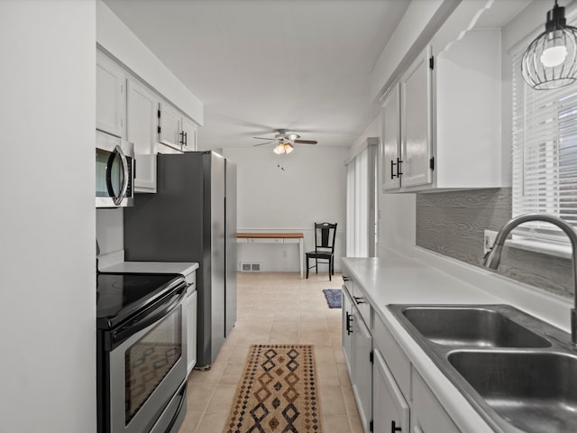 kitchen featuring white cabinets, a sink, appliances with stainless steel finishes, visible vents, and ceiling fan