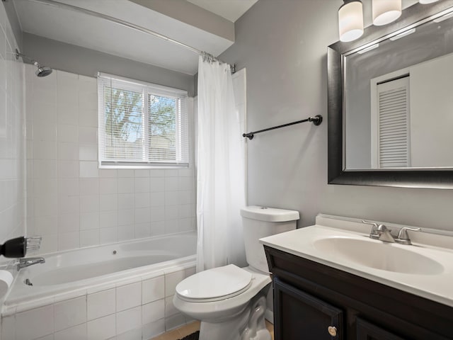 bathroom with tiled shower / bath combo, toilet, and vanity