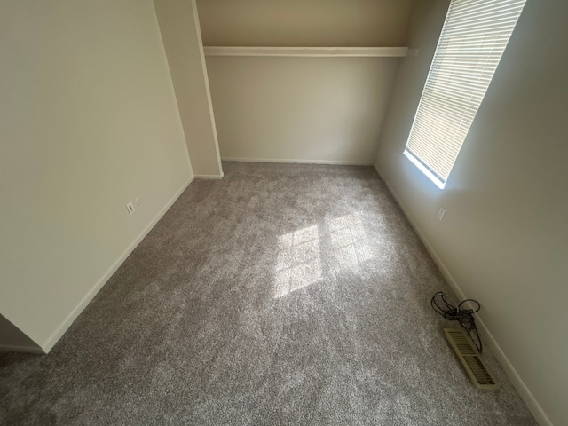 interior space featuring carpet floors and baseboards