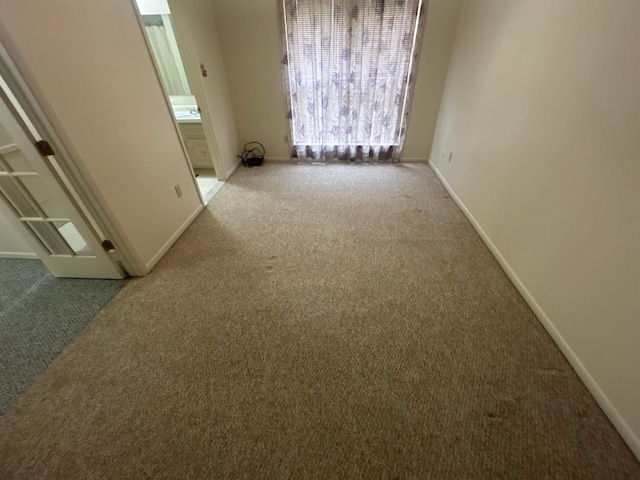 empty room with carpet floors and baseboards