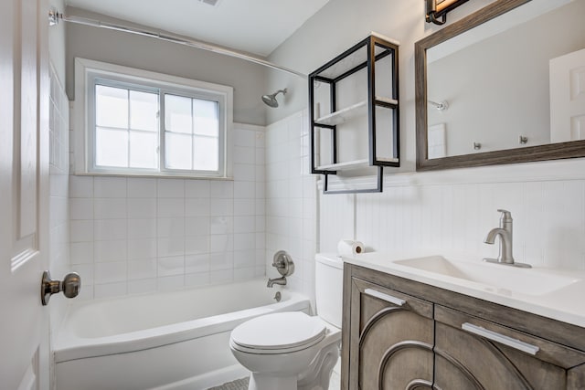 full bathroom with vanity, wainscoting, toilet, and shower / washtub combination