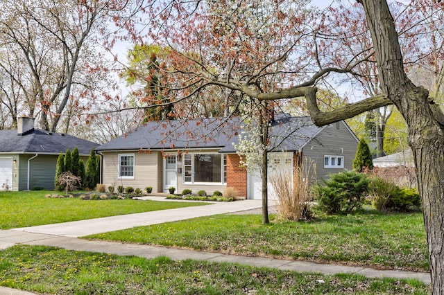 ranch-style house with a garage, concrete driveway, and a front yard