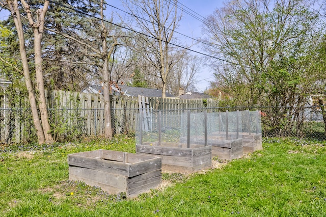 view of yard with fence and a garden