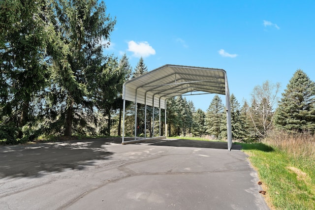 5480 Kensington Rd, Brighton, MI 48114 - view of parking featuring driveway and a detached carport