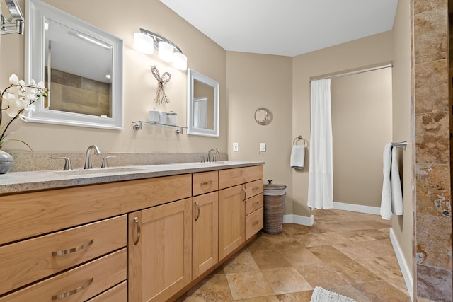 5480 Kensington Rd, Brighton, MI 48114 - bathroom featuring baseboards, double vanity, stone finish floors, and a shower