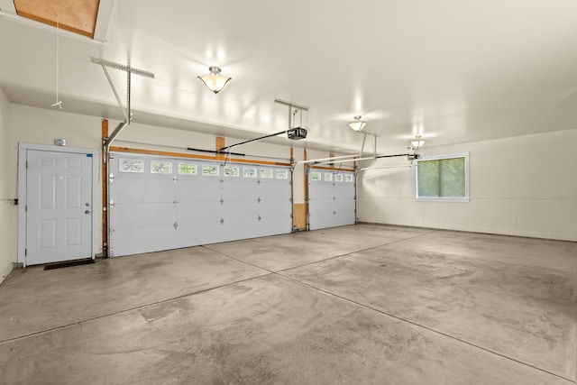 5480 Kensington Rd, Brighton, MI 48114 - garage featuring a garage door opener