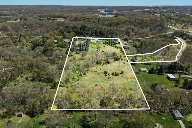 5480 Kensington Rd, Brighton, MI 48114 - aerial view of property and surrounding area with property parcel outlined and a forest