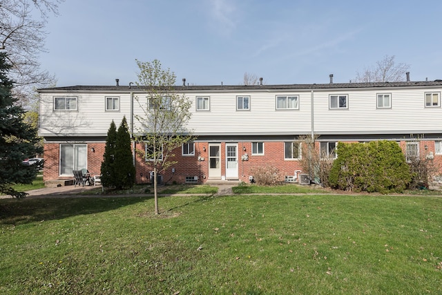 3134 Williamsburg Rd, Ann Arbor, MI 48108 - rear view of house with a lawn, entry steps, a patio area, and brick siding
