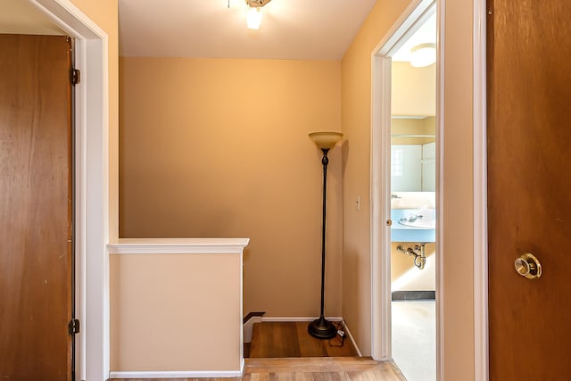 3134 Williamsburg Rd, Ann Arbor, MI 48108 - hallway featuring baseboards, wood finished floors, and an upstairs landing