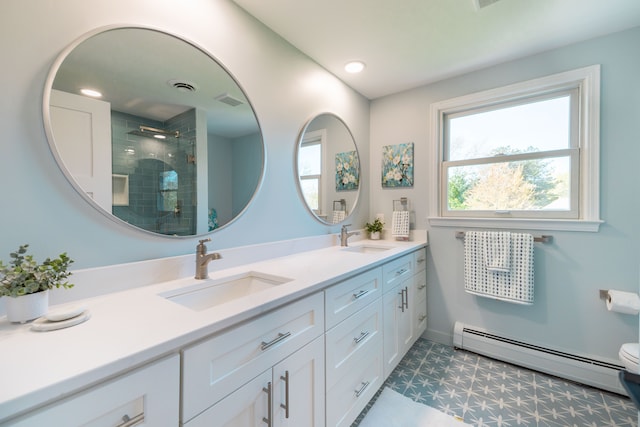 full bath featuring a sink, a baseboard heating unit, tile patterned floors, and a shower stall