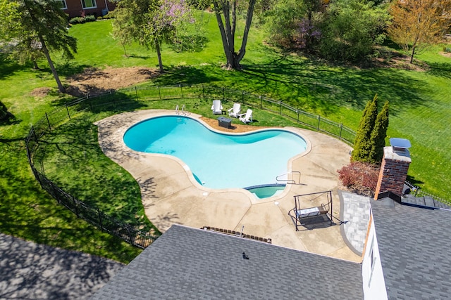 pool with fence, a patio, and a lawn