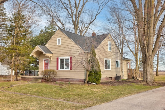 1743 Midland Rd, Bay City, MI 48706 - bungalow-style home with a front yard, a shingled roof, a chimney, and central AC
