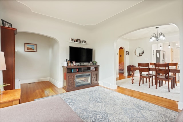 1743 Midland Rd, Bay City, MI 48706 - living area featuring wood finished floors, baseboards, and a chandelier