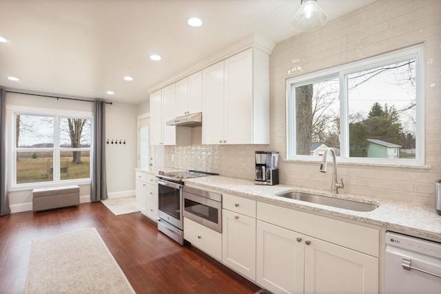 1743 Midland Rd, Bay City, MI 48706 - kitchen with a sink, dishwasher, under cabinet range hood, stainless steel electric range, and decorative backsplash