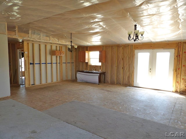 7640 S Lake Pleasant Rd, Osseo, MI 49266 - unfurnished living room with a chandelier