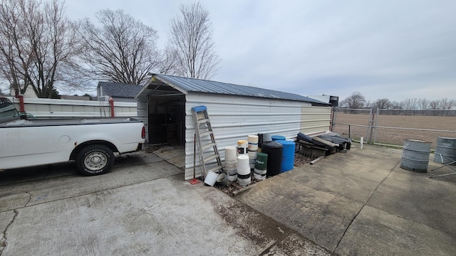 view of outbuilding with fence