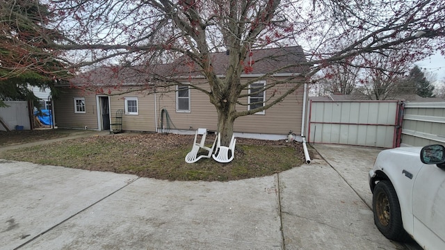 view of side of property with roof with shingles