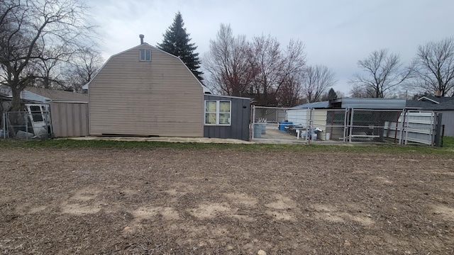 exterior space with fence and an outbuilding