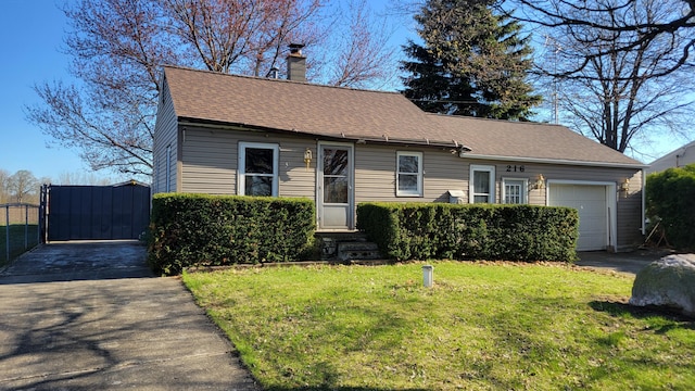 view of front facade with a chimney, a gate, a garage, entry steps, and a front lawn