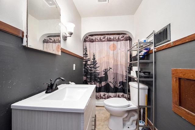 full bath featuring vanity, toilet, and visible vents