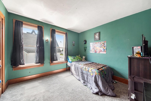 carpeted bedroom with baseboards