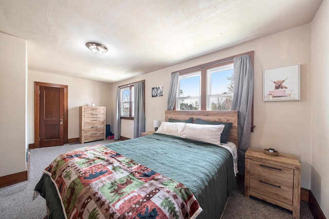 carpeted bedroom featuring baseboards