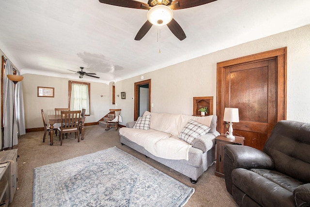 living room featuring baseboards, a ceiling fan, and light colored carpet