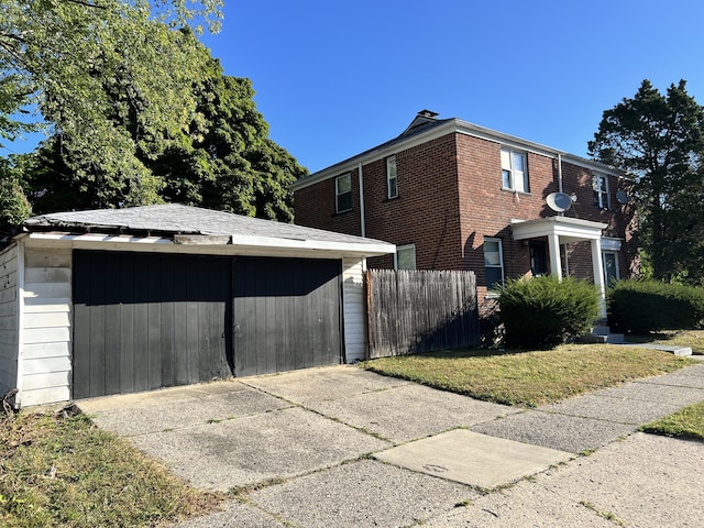 view of side of property with a chimney, brick siding, and fence