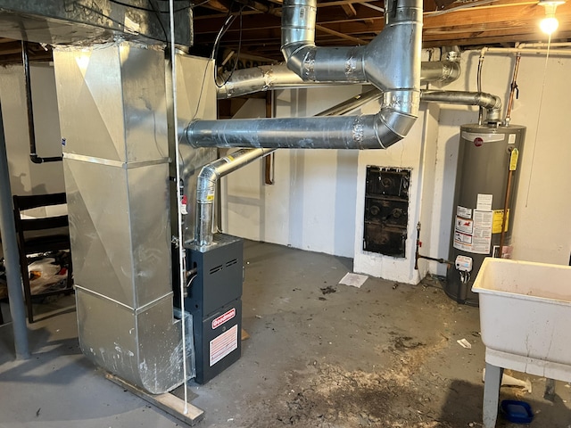 utility room with heating unit, water heater, and a sink